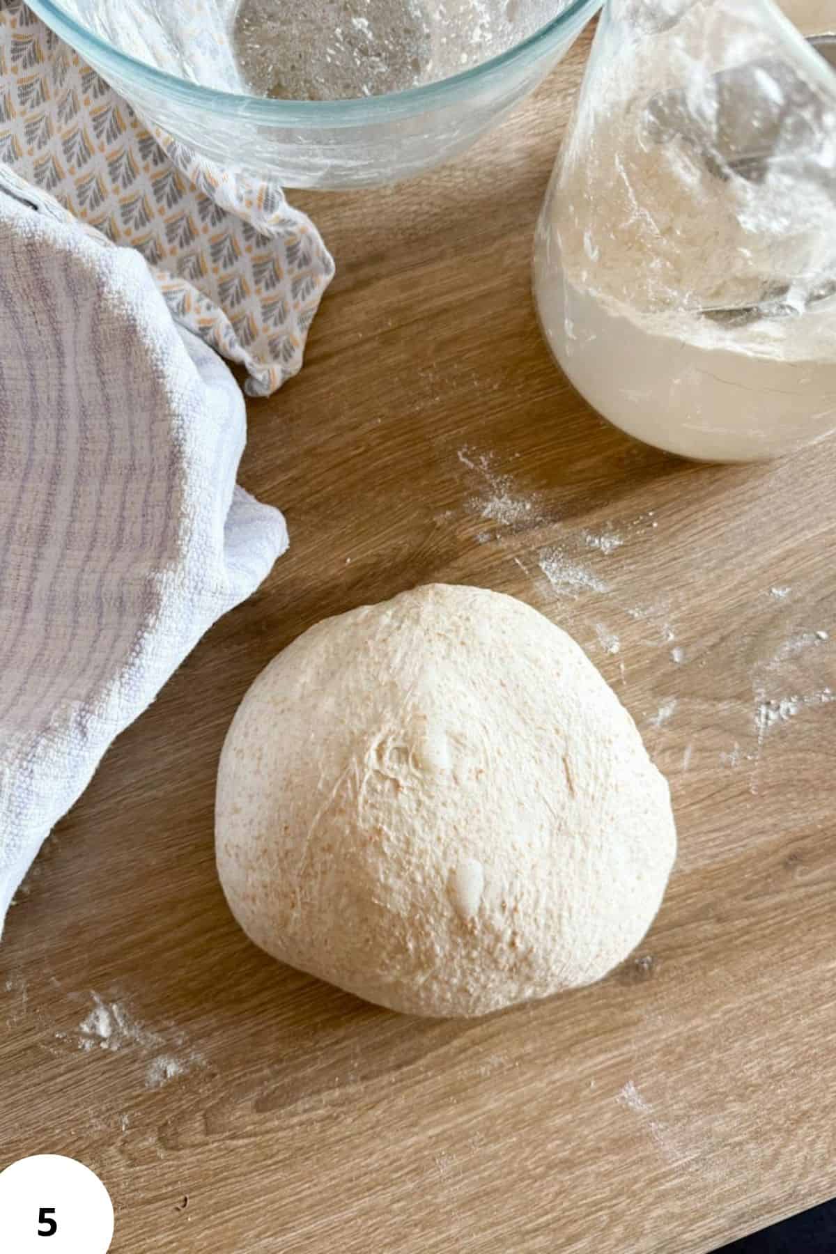 Fresh milled recipes with homemade bread dough on wooden surface.