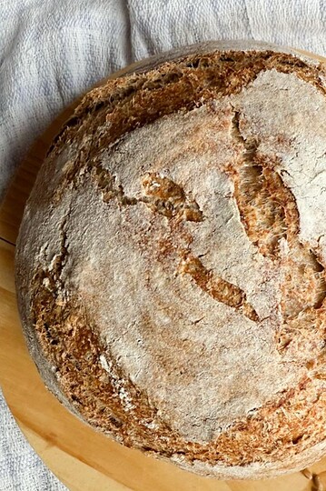 Leavened with natural sourdough starter, this crusty bread showcases fresh milled ingredients for wholesome baking.