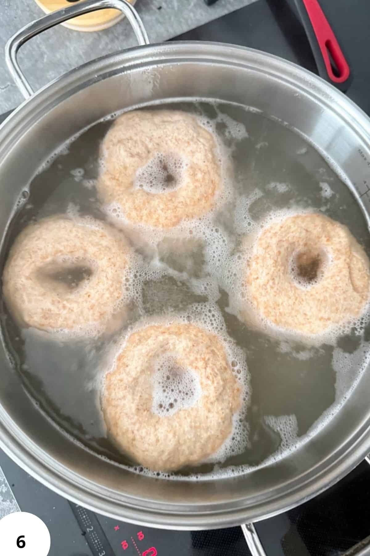 Eggplant slices boiling for breading process.