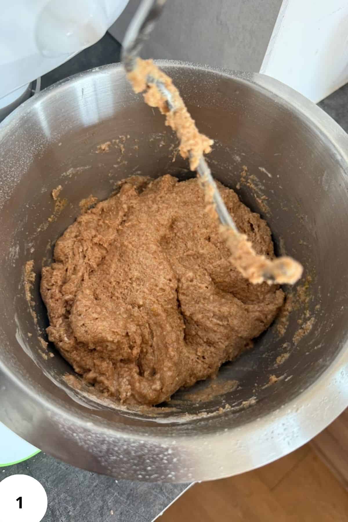 Freshly mixed bread dough in a metal bowl for baking.