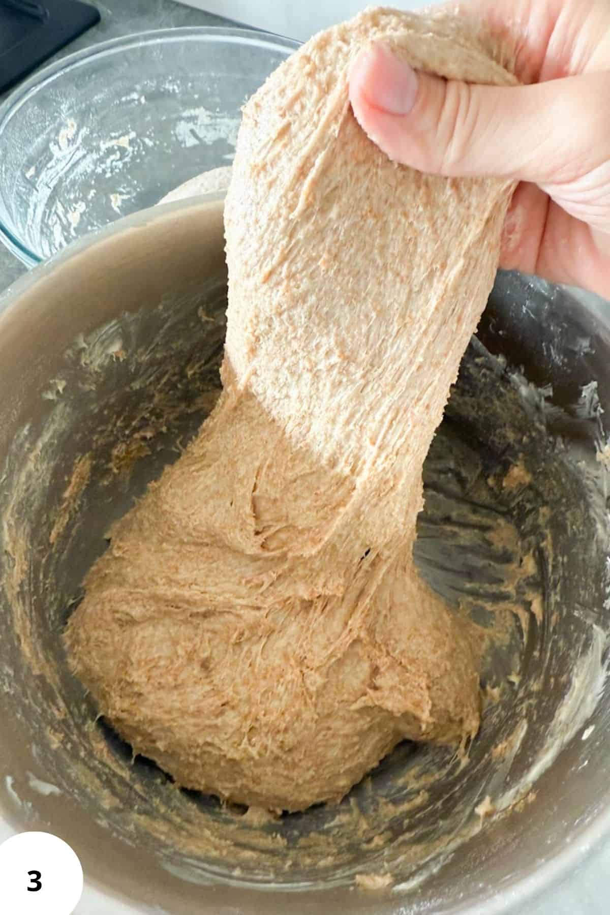 Healthy whole wheat flour dough in a stand mixer bowl for bread or baking.
