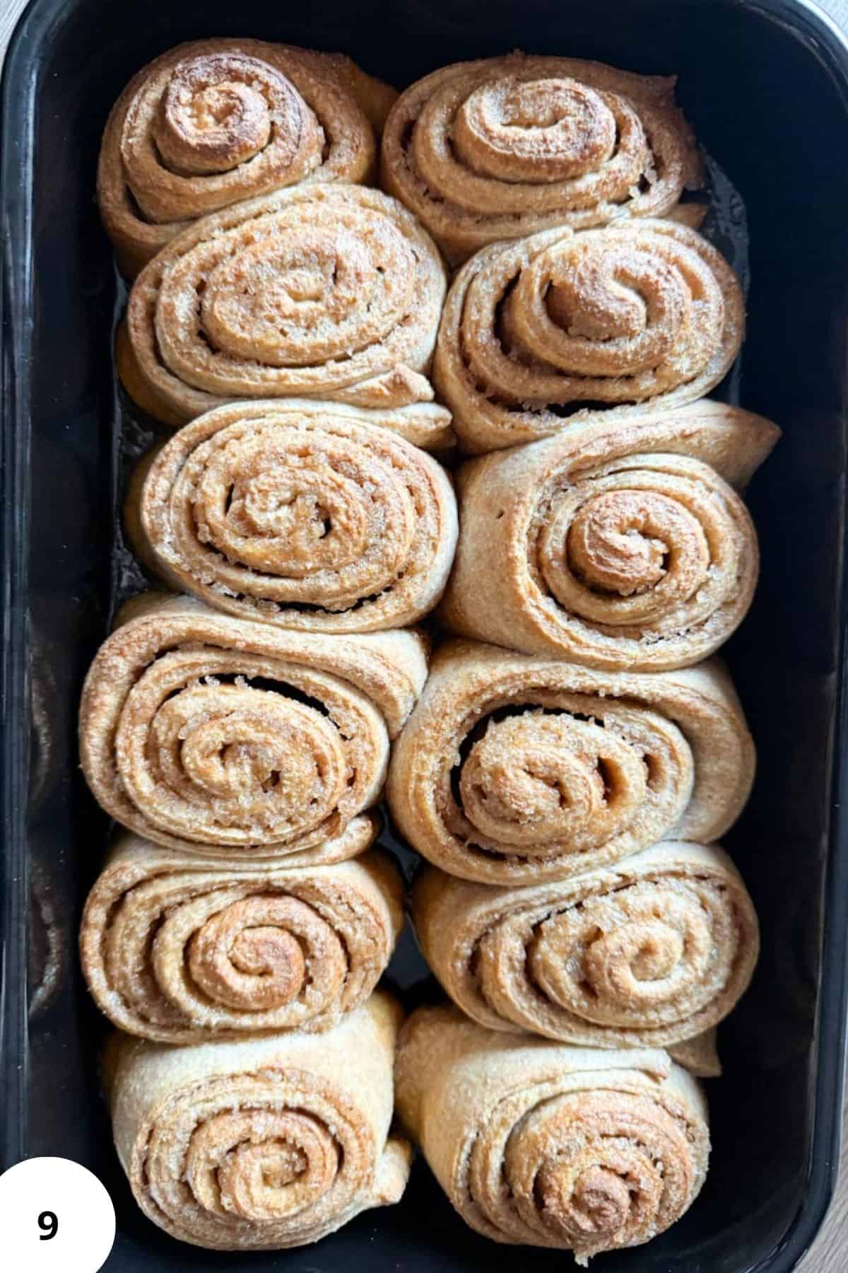 Delicious freshly baked cinnamon rolls with swirled cinnamon filling and a dusting of powdered sugar.