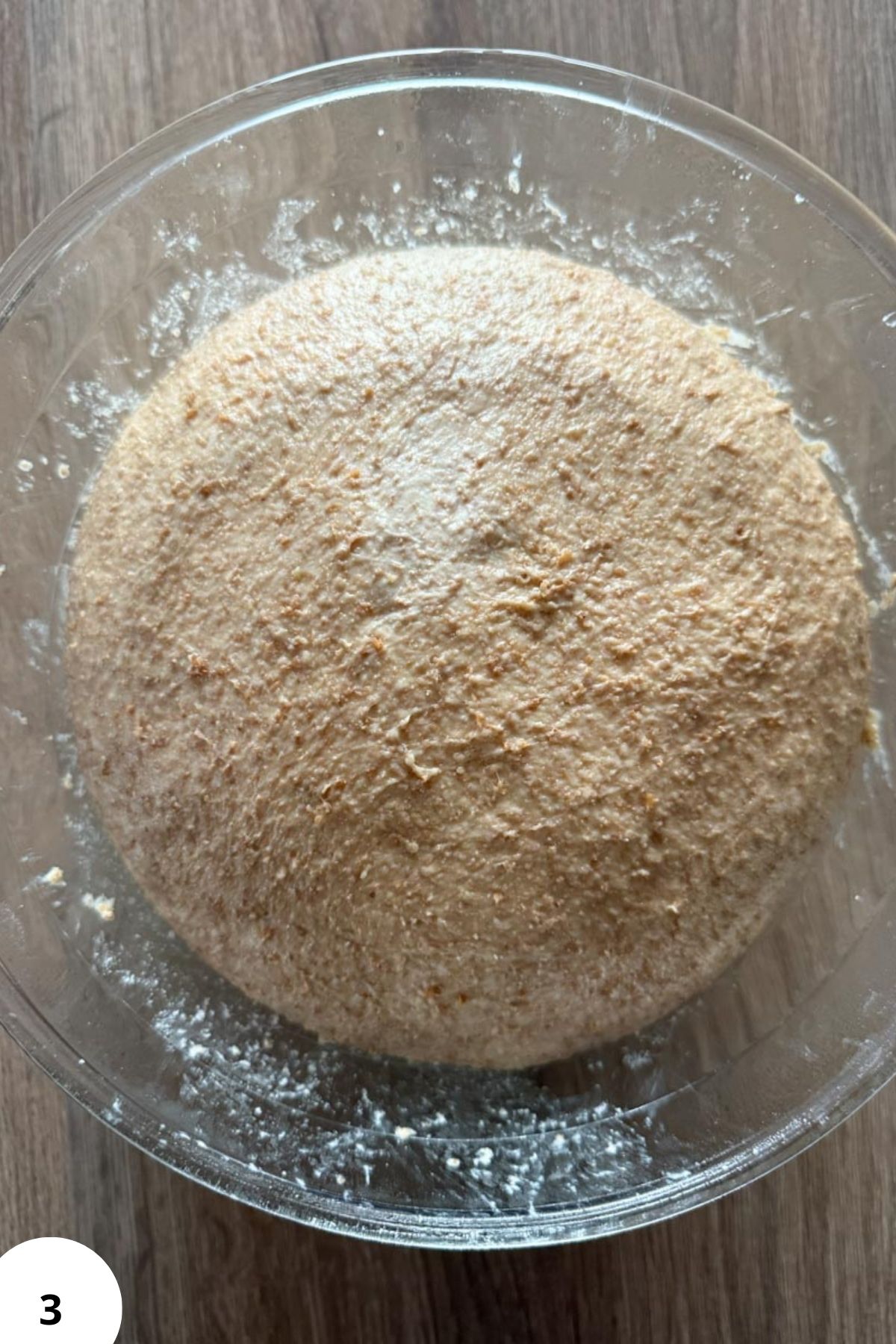 Clean, freshly ground whole grain flour in a clear glass bowl.