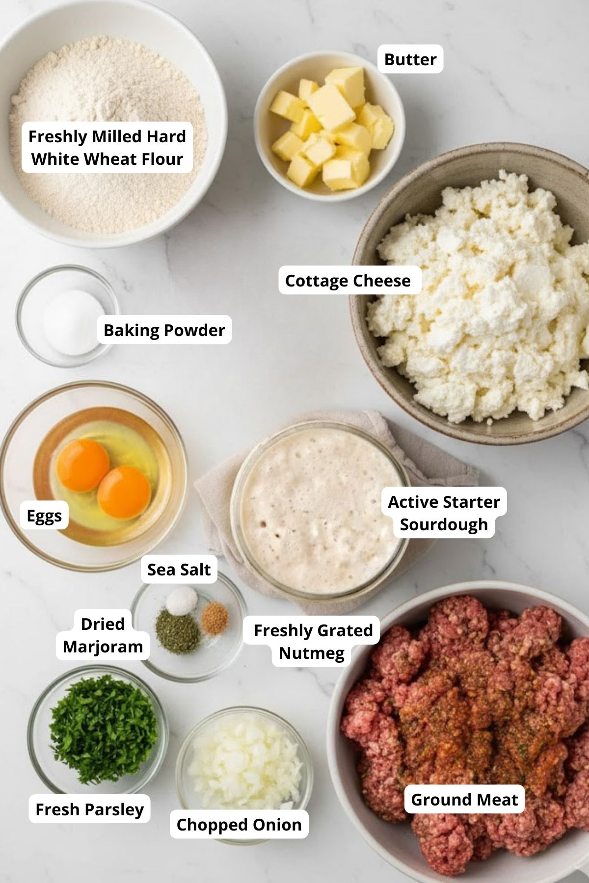 Ingredients for meat roll arranged in a marble surface.