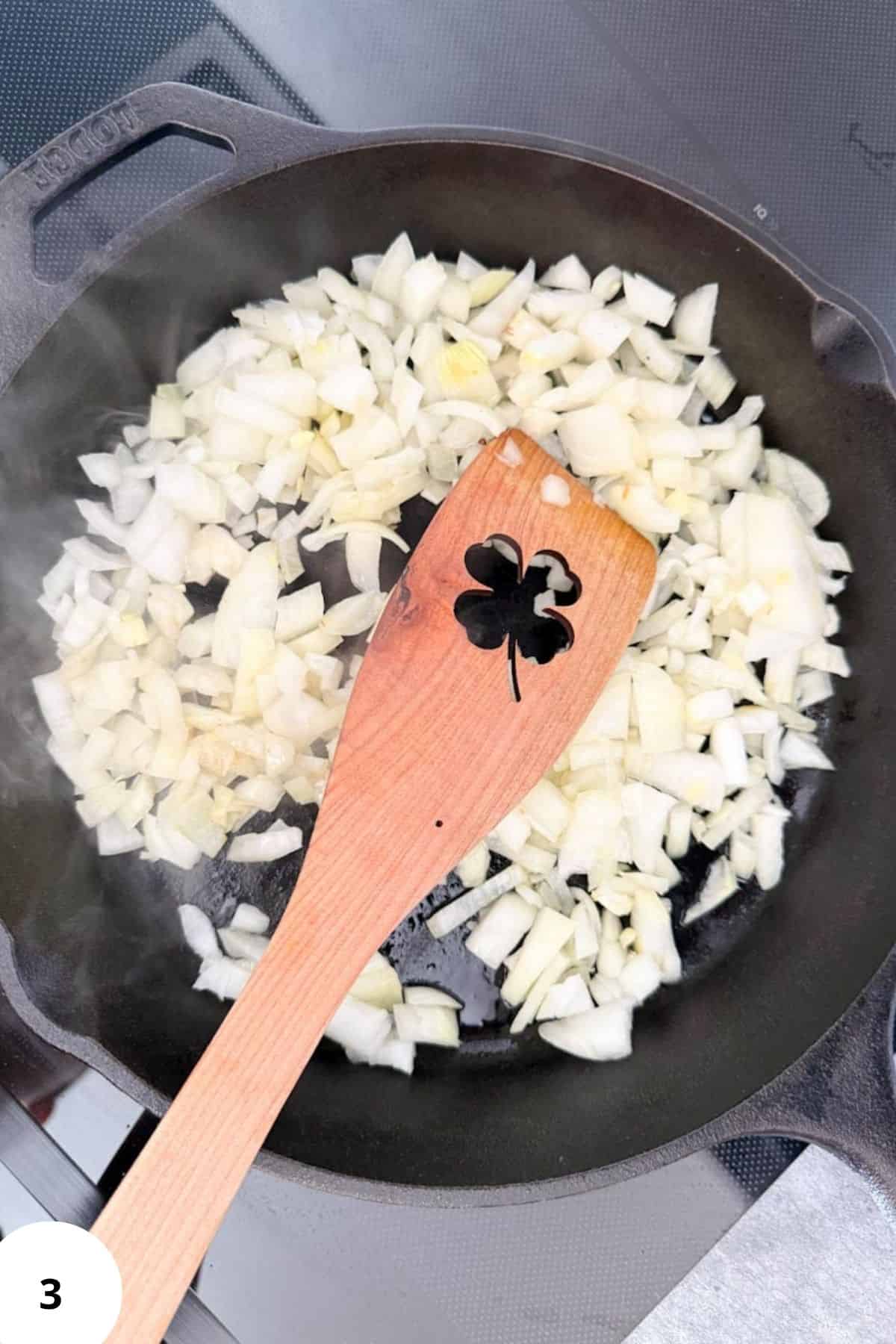 Sautéed chopped onions in a cast iron skillet for fresh milled recipes and flavorful cooking.