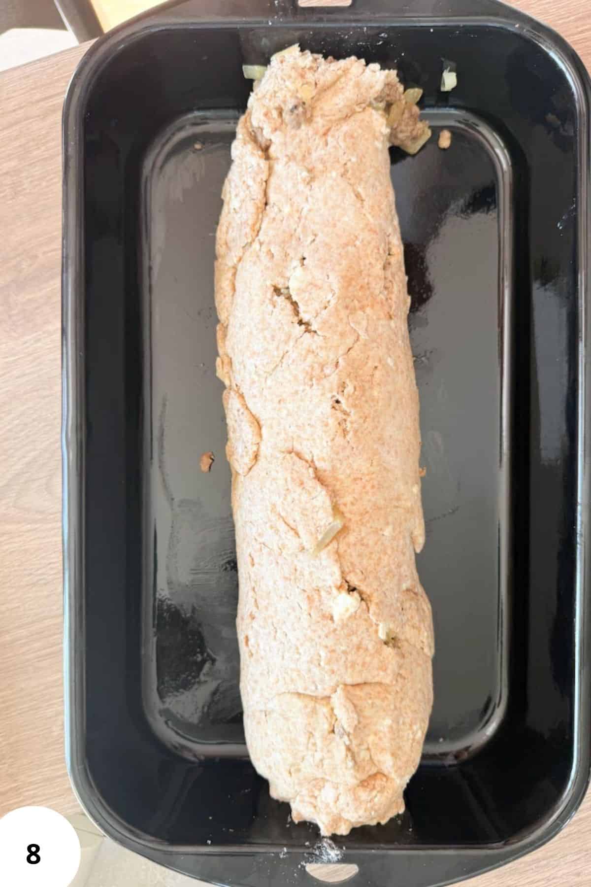 Freshly baked bread loaf in a baking dish.