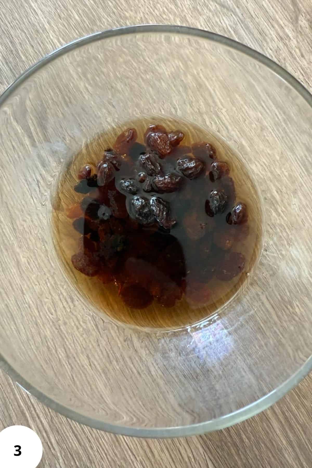 Raisins soaked in water, ideal for baking, snacking, and homemade recipes with fresh ingredients.