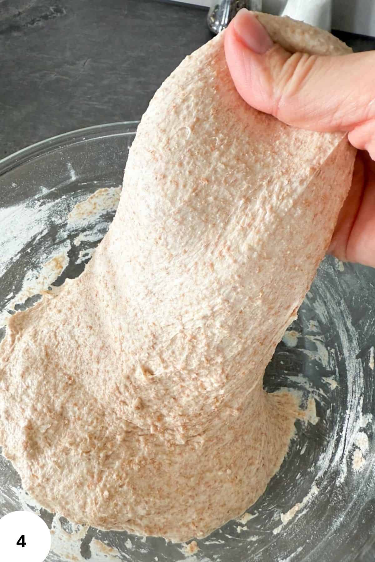 Close-up of fresh milled whole wheat flour in a glass bowl after grinding.