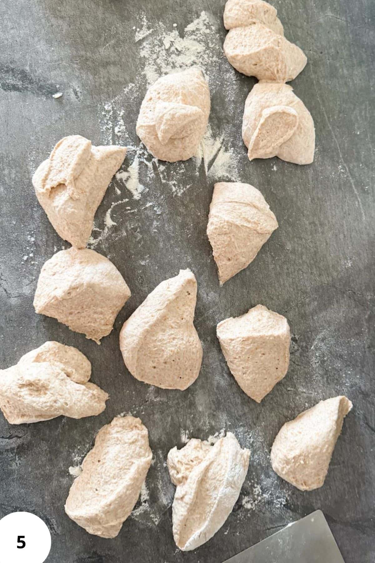 Freshly prepared dough pieces for homemade flour tortillas on a textured surface.