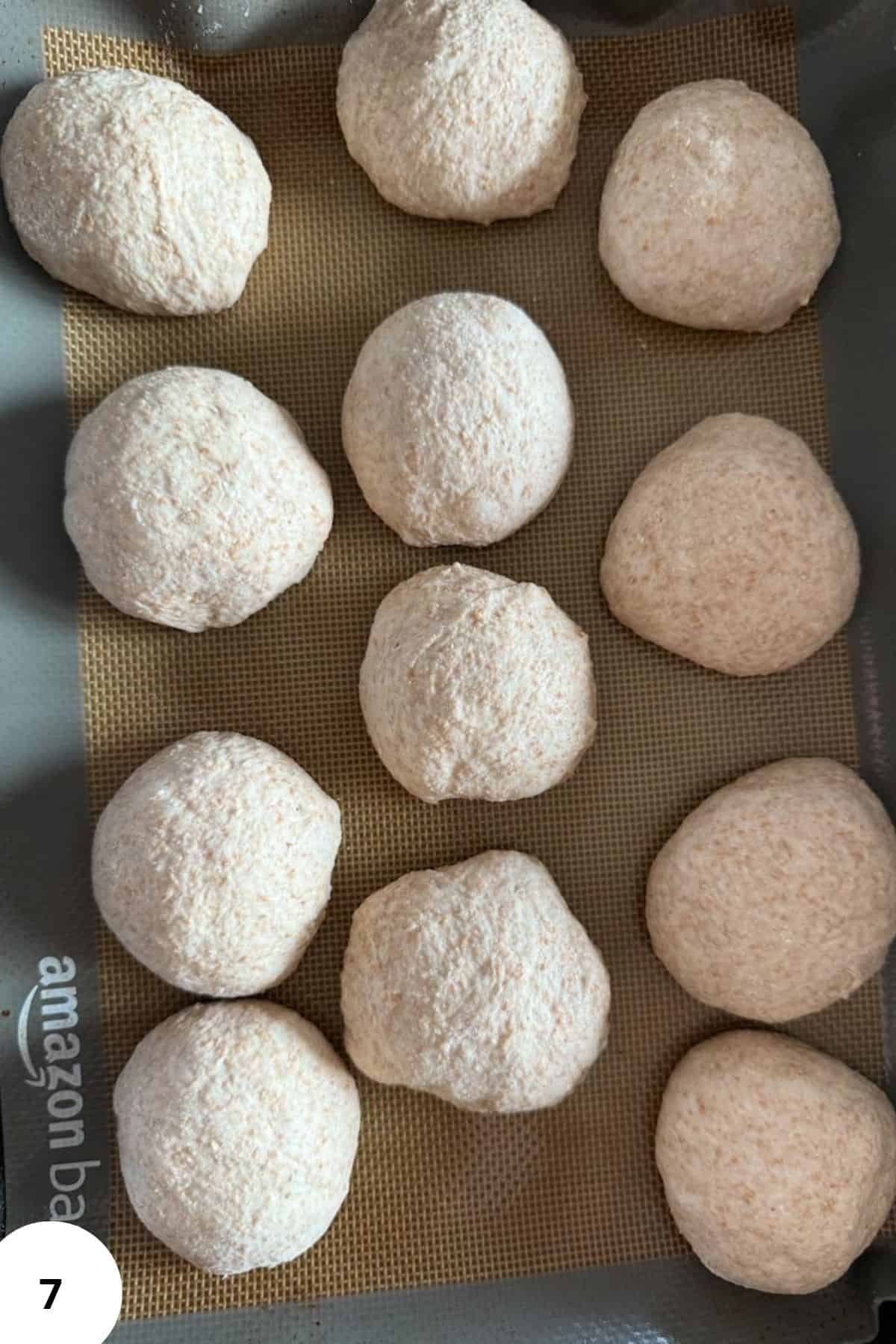 Homemade bread balls coated with flour, freshly baked, perfect for baking or snacking.