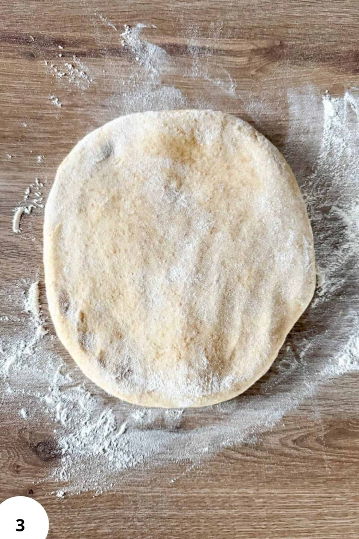 Healthy homemade bread dough with freshly milled grains on wooden surface.