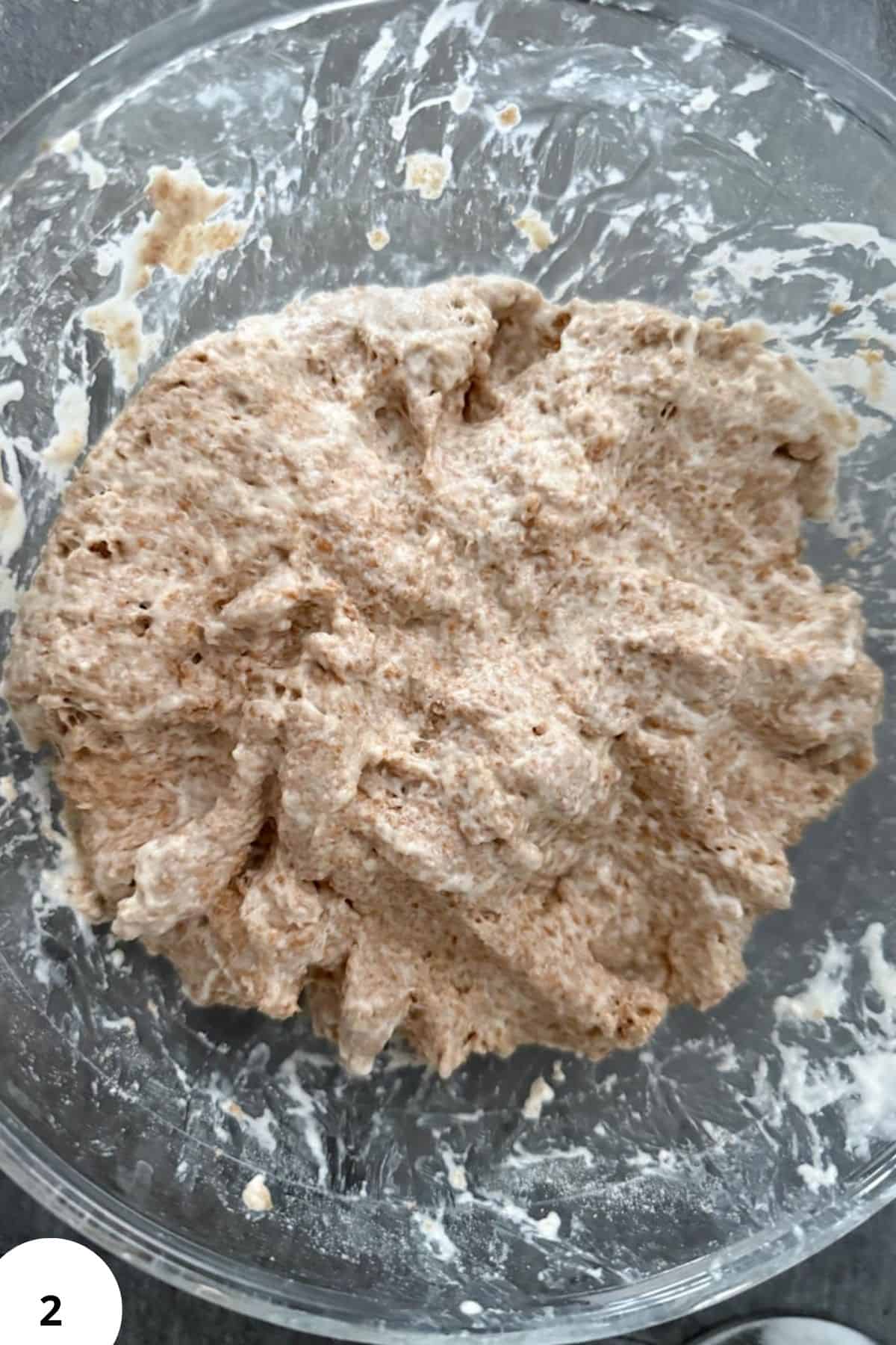 Close-up of fresh milled dough in a glass bowl, perfect for wholesome baking and homemade bread.