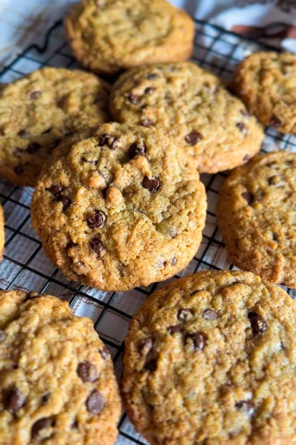 Homemade chocolate chip cookies on a cooling rack, showcasing fresh milled ingredients for delicious baking.