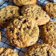 Delicious homemade chocolate chip cookies made with fresh milled grains on a cooling rack.