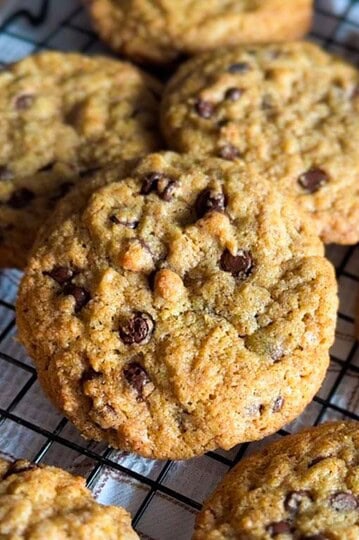 Delicious homemade chocolate chip cookies made with fresh milled grains on a cooling rack.