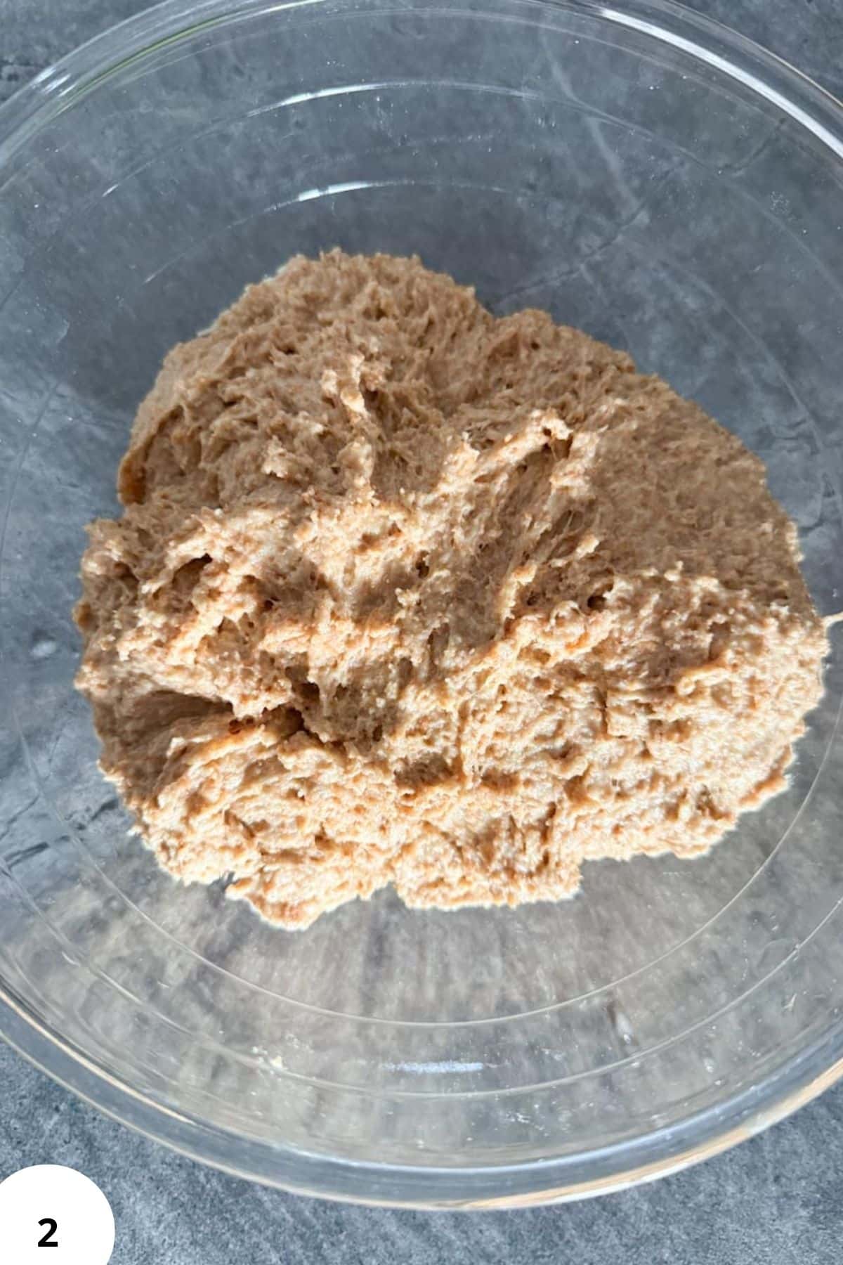 Fresh milled whole grain flour in a clear bowl, ideal for baking and healthy eating.