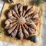 Decorative, flaky pastry with honey glaze and powdered sugar. Perfect for festive breakfast or dessert.