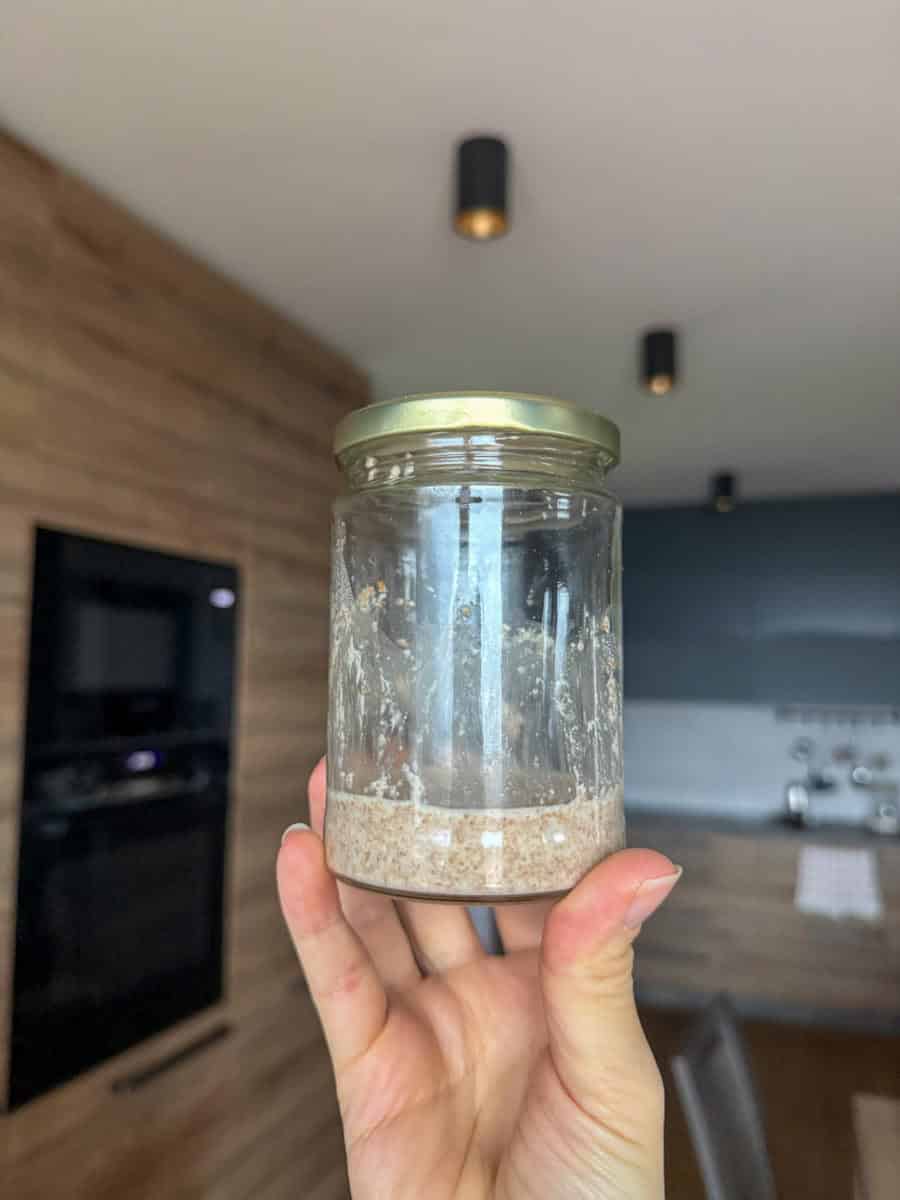 Sourdough starter made with fresh milled flour in a glass jar.