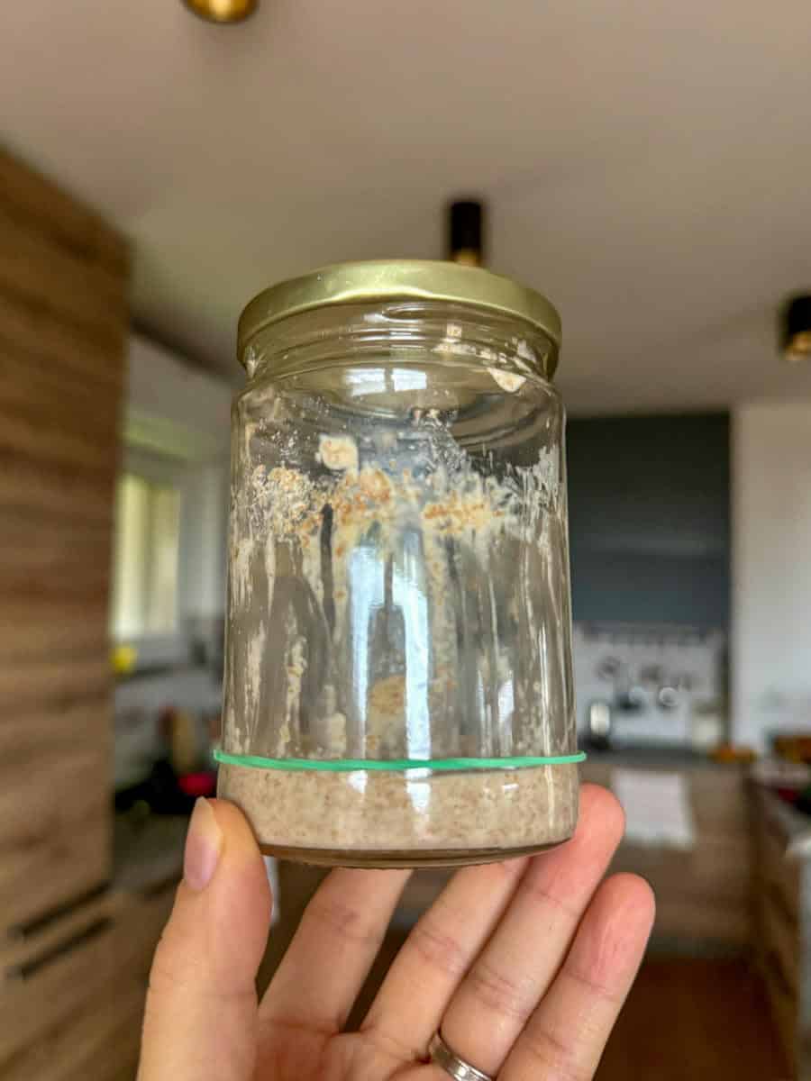 Sourdough starter made with fresh milled flour in a glass jar.