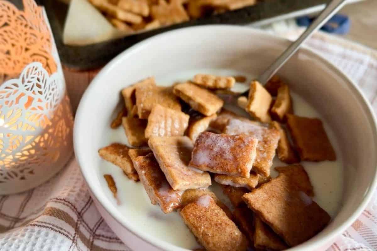 Cinnamon Toast Crunch cereal made from freshly milled ingredients, served with milk in a white bowl.