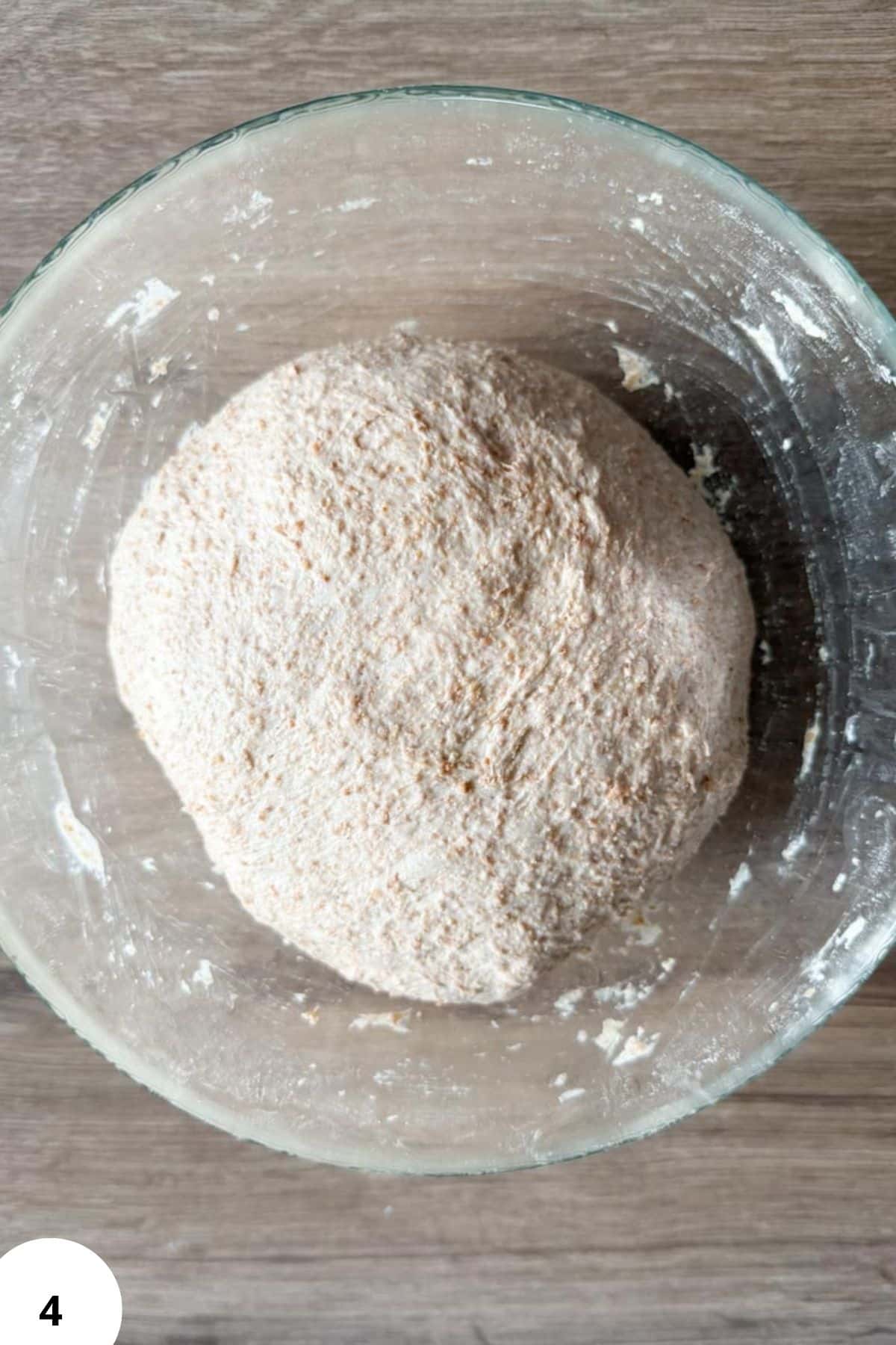 Fresh milled sourdough dough in a glass bowl, ready for baking using the two-pan method.