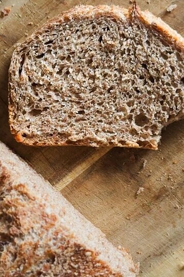 Sourdough bread made with fresh milled flour in a loaf pan, showcasing the two-pan baking method. Pe.