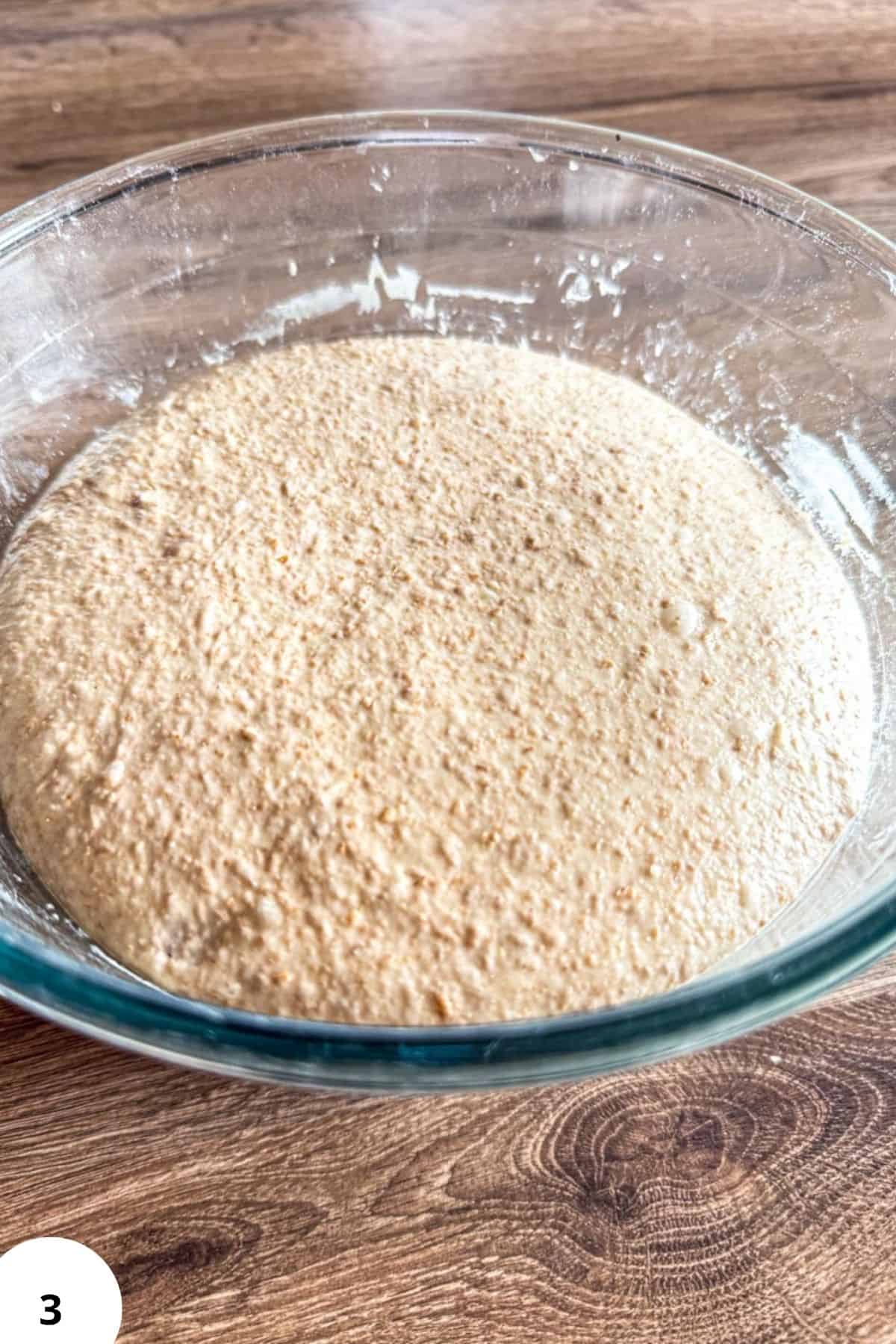 Freshly milled spelt flour in a glass bowl for sourdough bread baking.