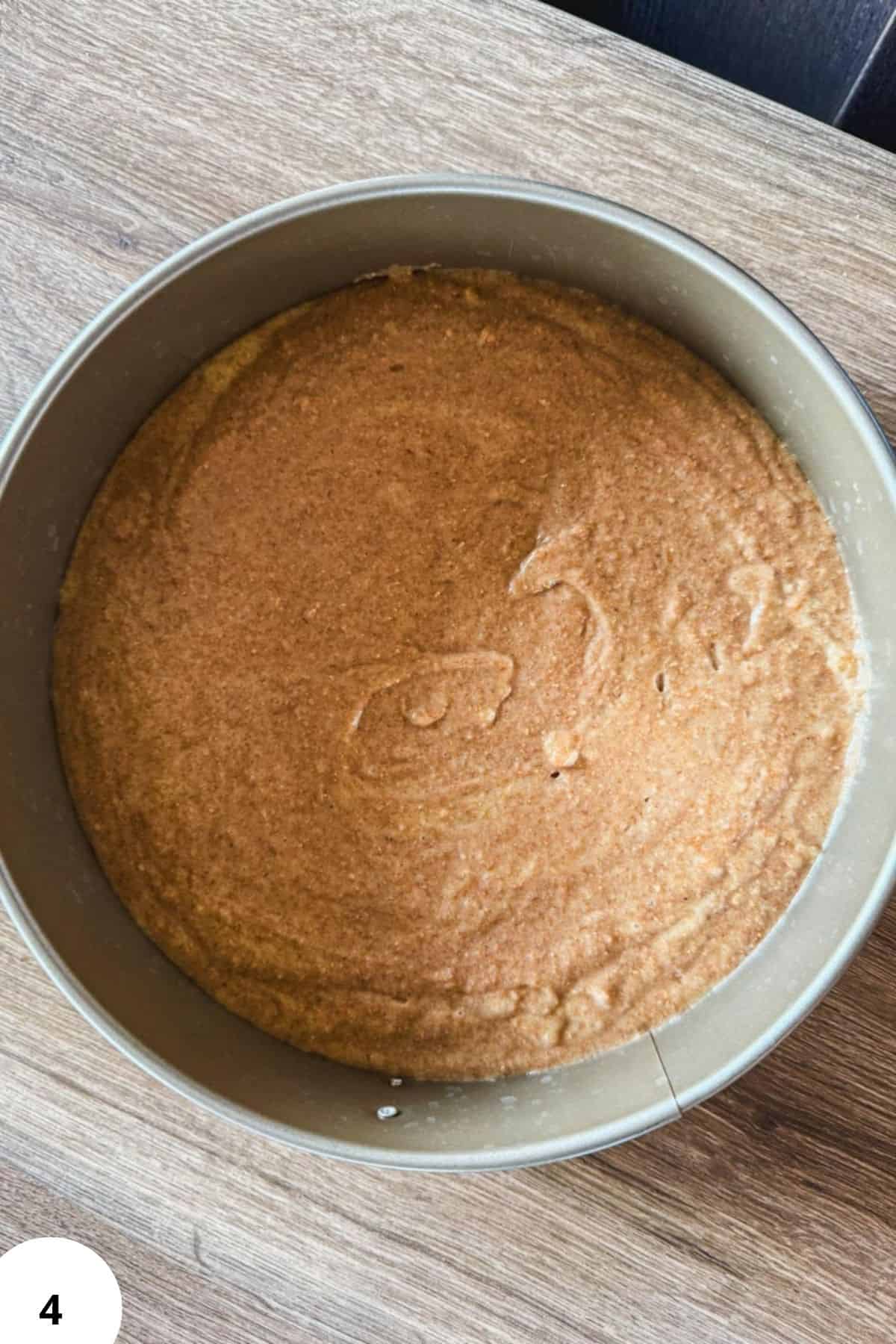 Freshly milled flour batter in a round baking pan for sour cherry chocolate cake.