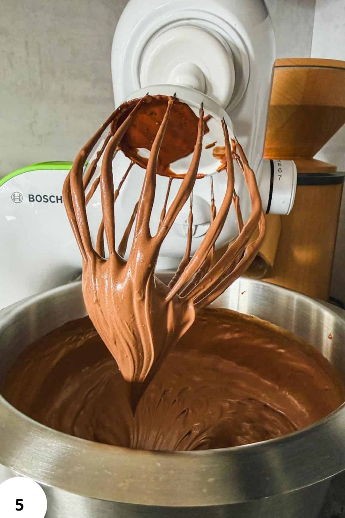 Freshly milled flour being mixed into chocolate cake batter with a stand mixer.