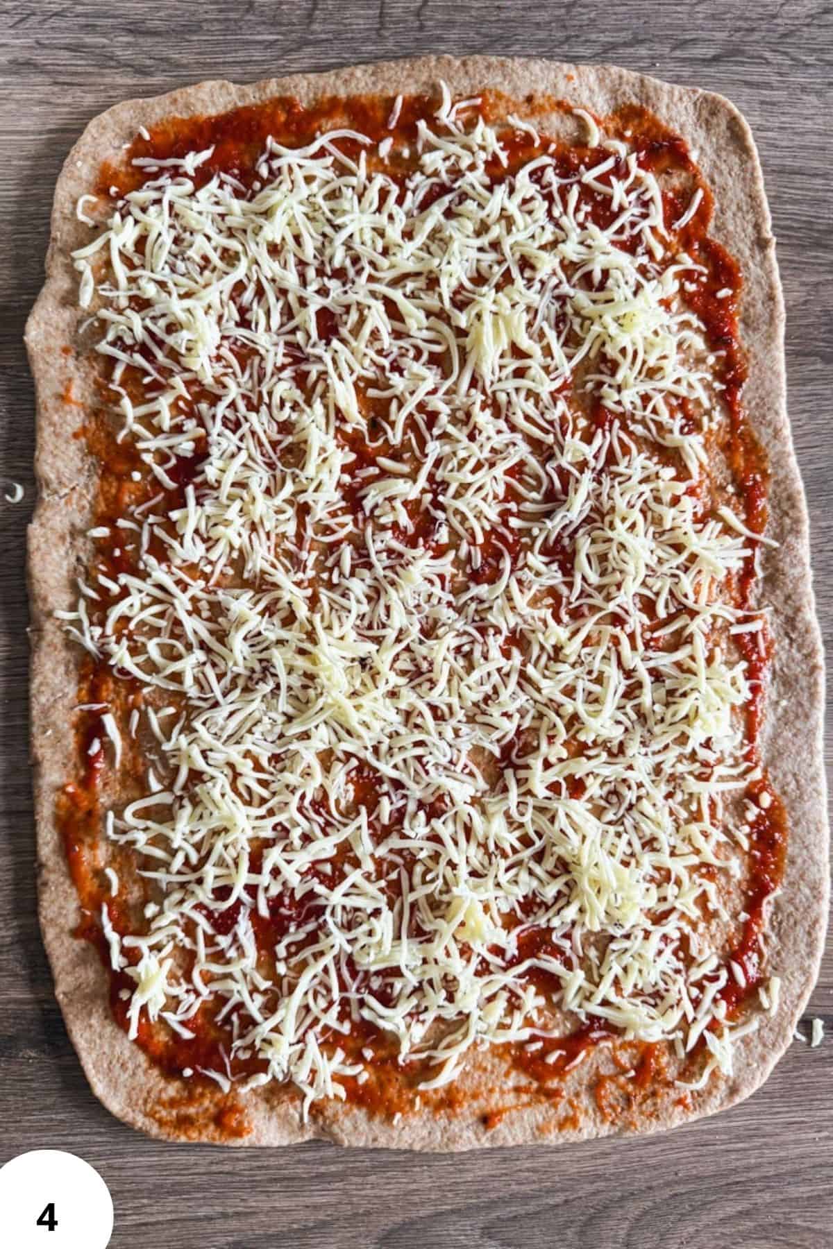 Homemade sourdough pizza rolls topped with fresh milled flour, soft and cheesy, perfect for a delici.