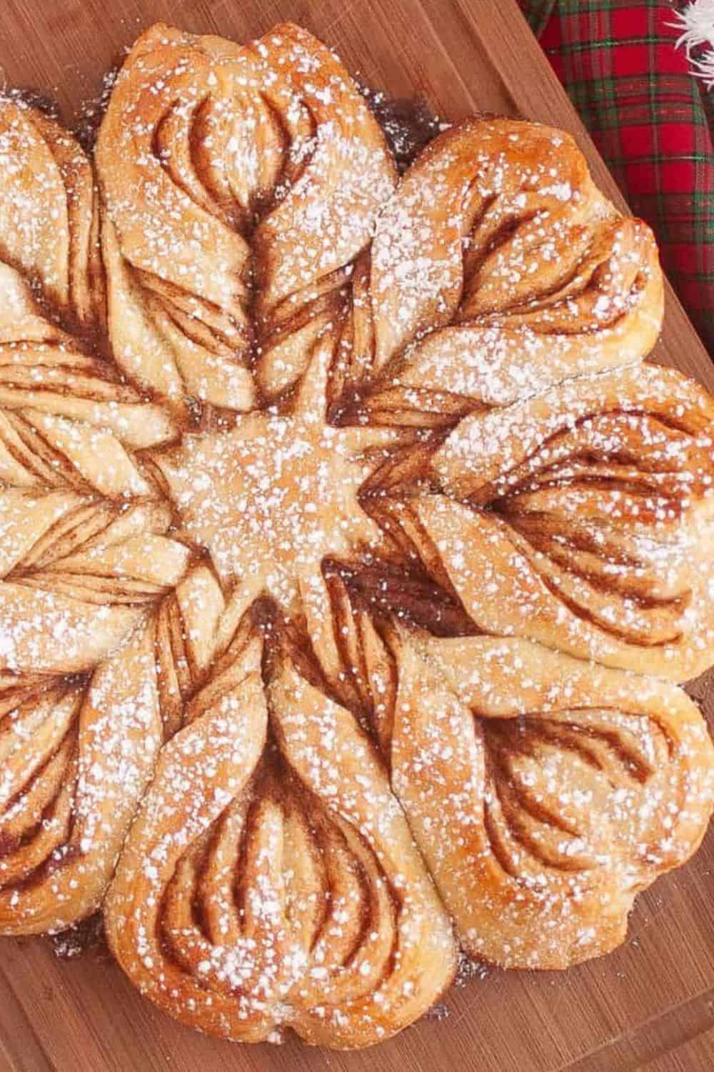 Sourdough bread with flaky, golden layers, dusted with powdered sugar, perfect for breakfast or dess.