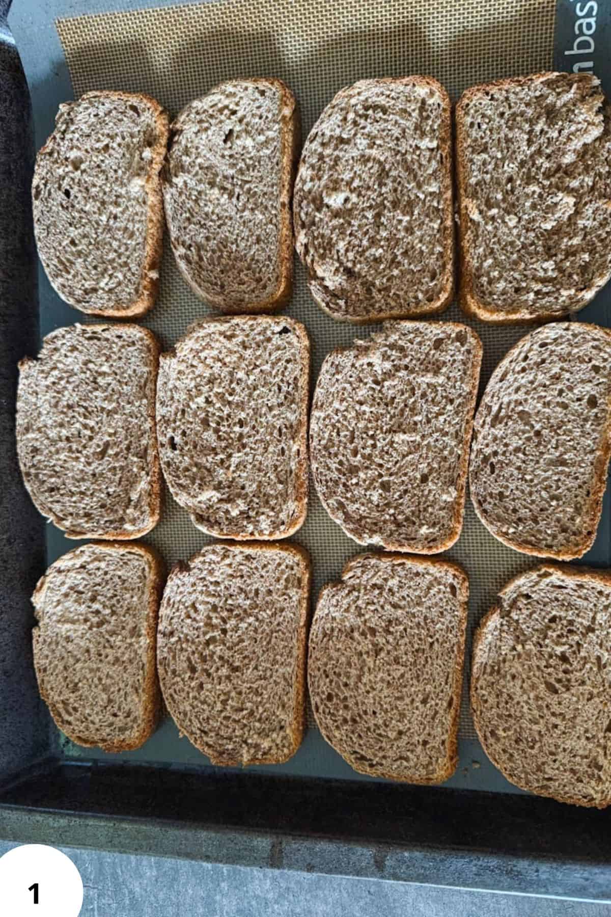 Whole grain bread slices dusted with flour for baking or toast.