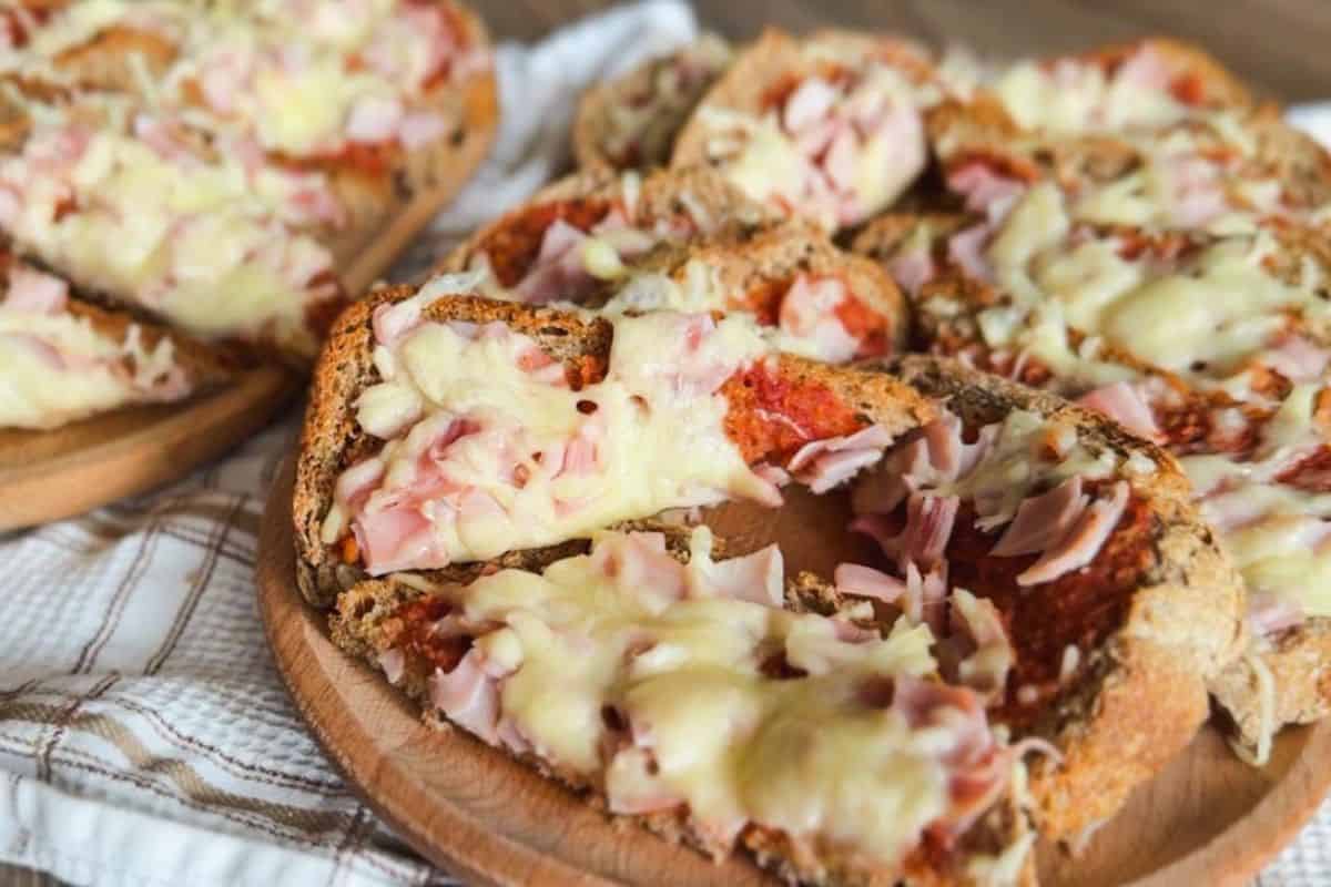 Delicious homemade pizza bread topped with melted cheese and ham. Perfect for snacks or casual meals.