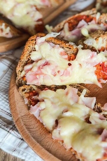 Delicious sourdough pizza toast topped with melted cheese and ham, made with freshly milled flour fo.