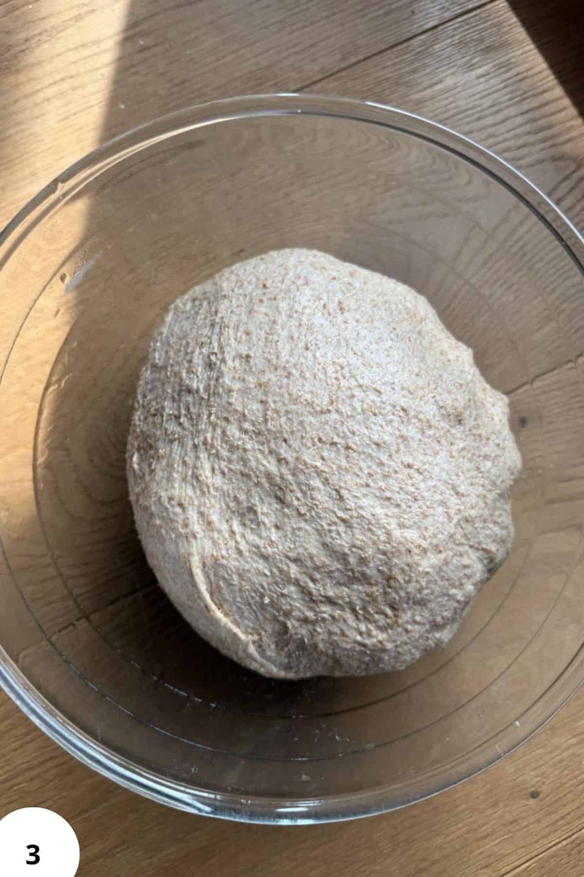 Freshly prepared sourdough bread dough in a glass bowl for homemade baking.