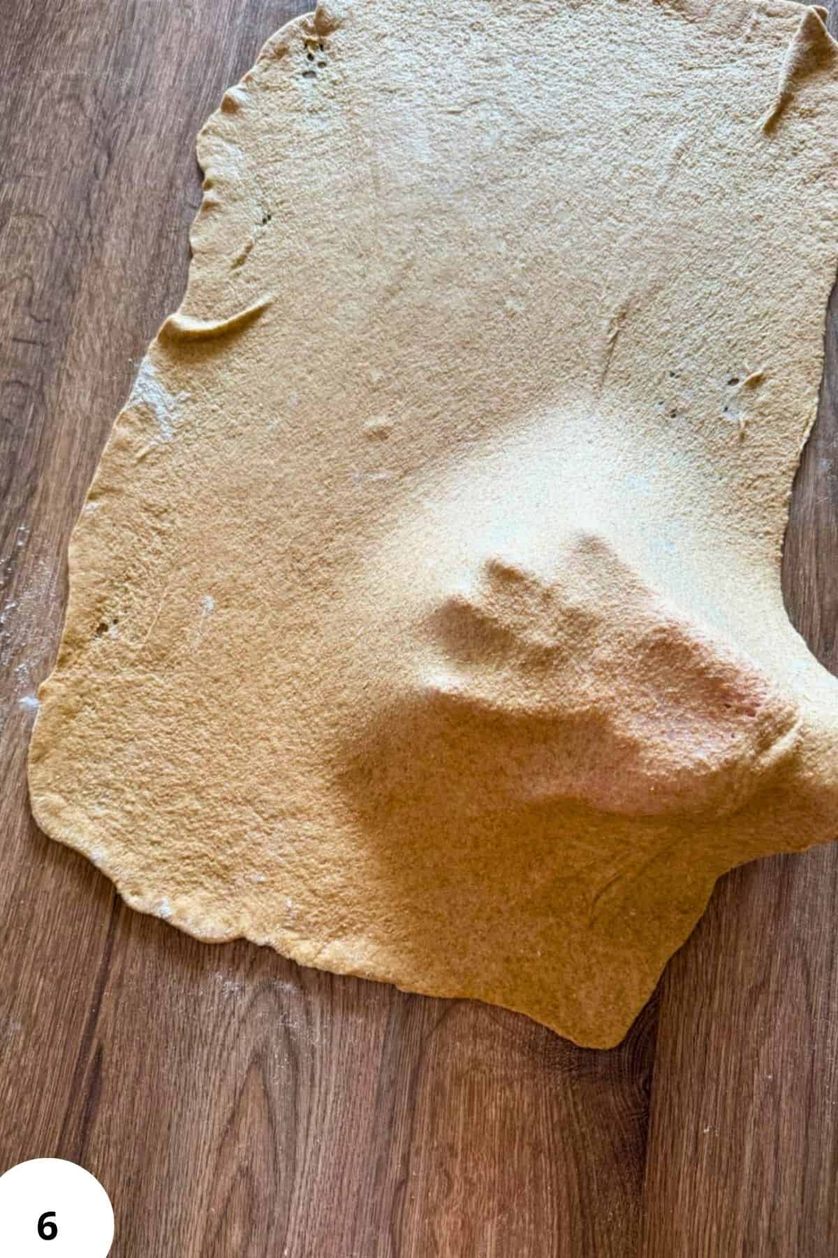 Close-up of fresh milled flour on a rustic wooden table.