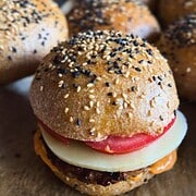 Close-up of a homemade burger slider with fresh ingredients and sesame seed bun.
