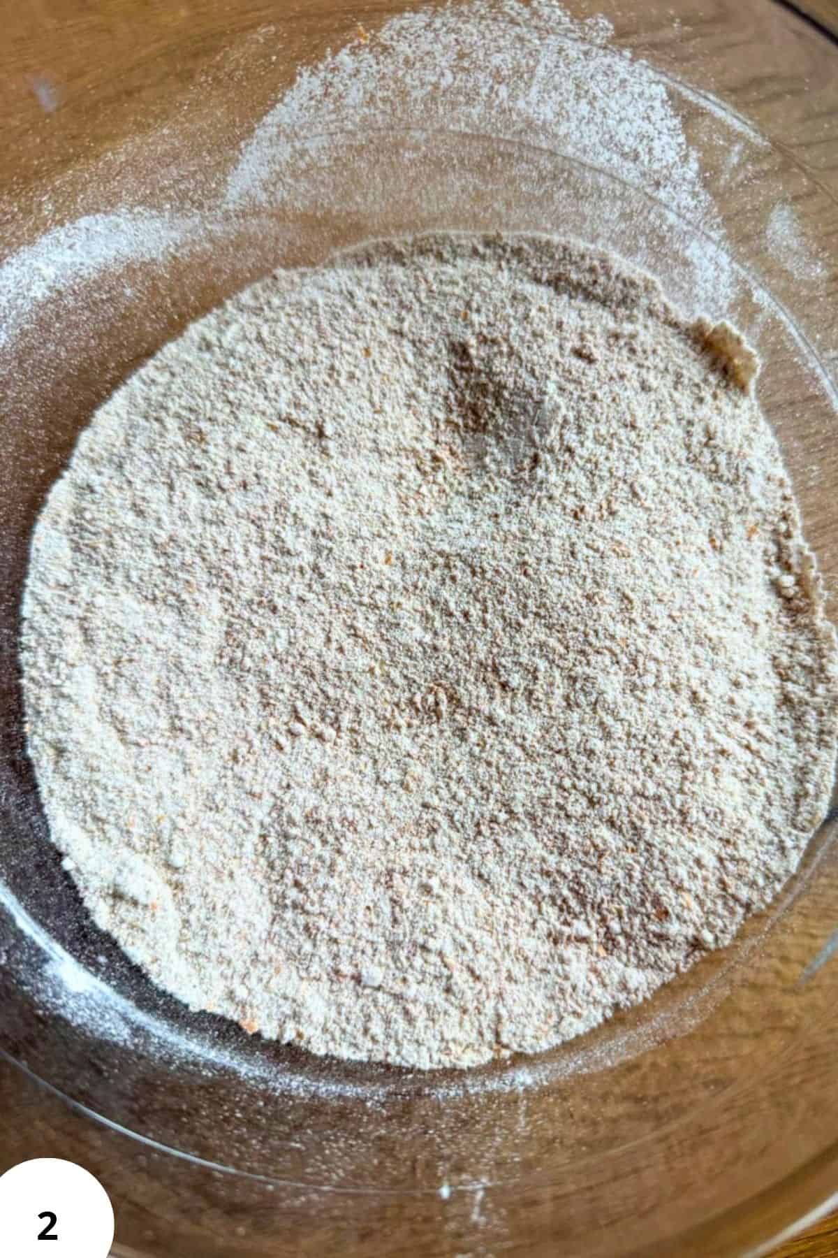 Freshly milled flour in a glass bowl for baking cookies.