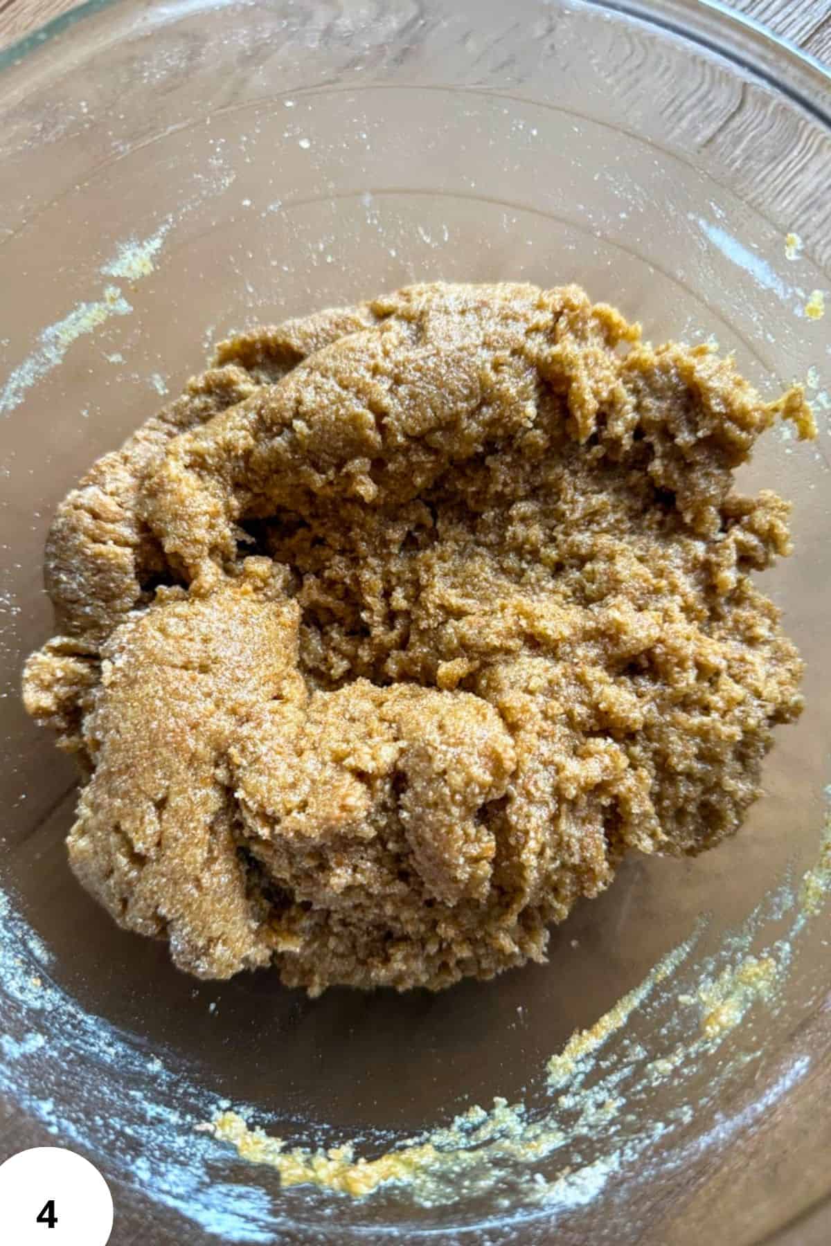 Close-up of fresh milled cookie dough in a glass bowl for soft cookies.
