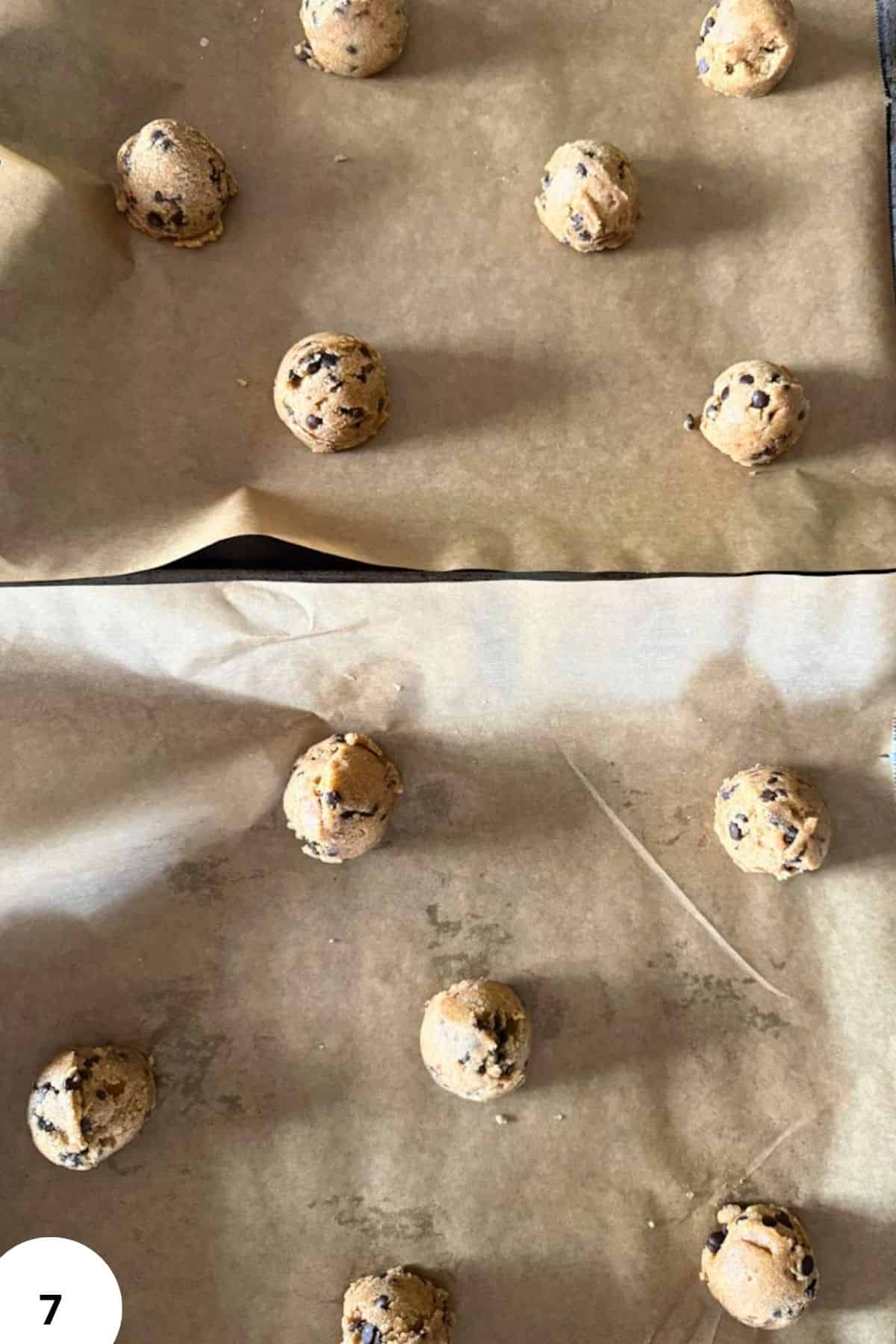 Raw cookie dough balls with chocolate chips on baking parchment.