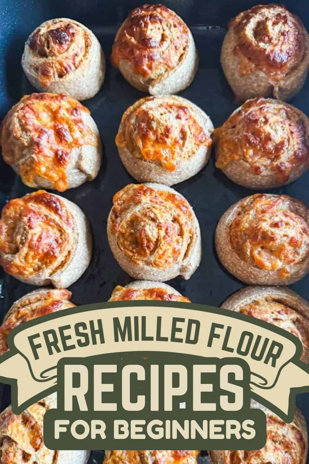 Freshly baked bread rolls made with milled flour on a baking tray.