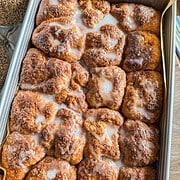 Close-up of cinnamon roll pull-apart focaccia with glaze and cinnamon sugar topping.