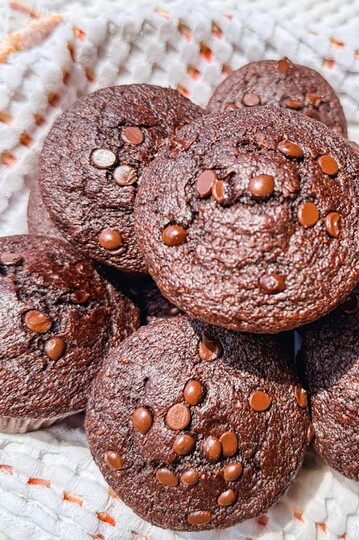 Chocolate zucchini muffins with chocolate chips on top, fresh and homemade.