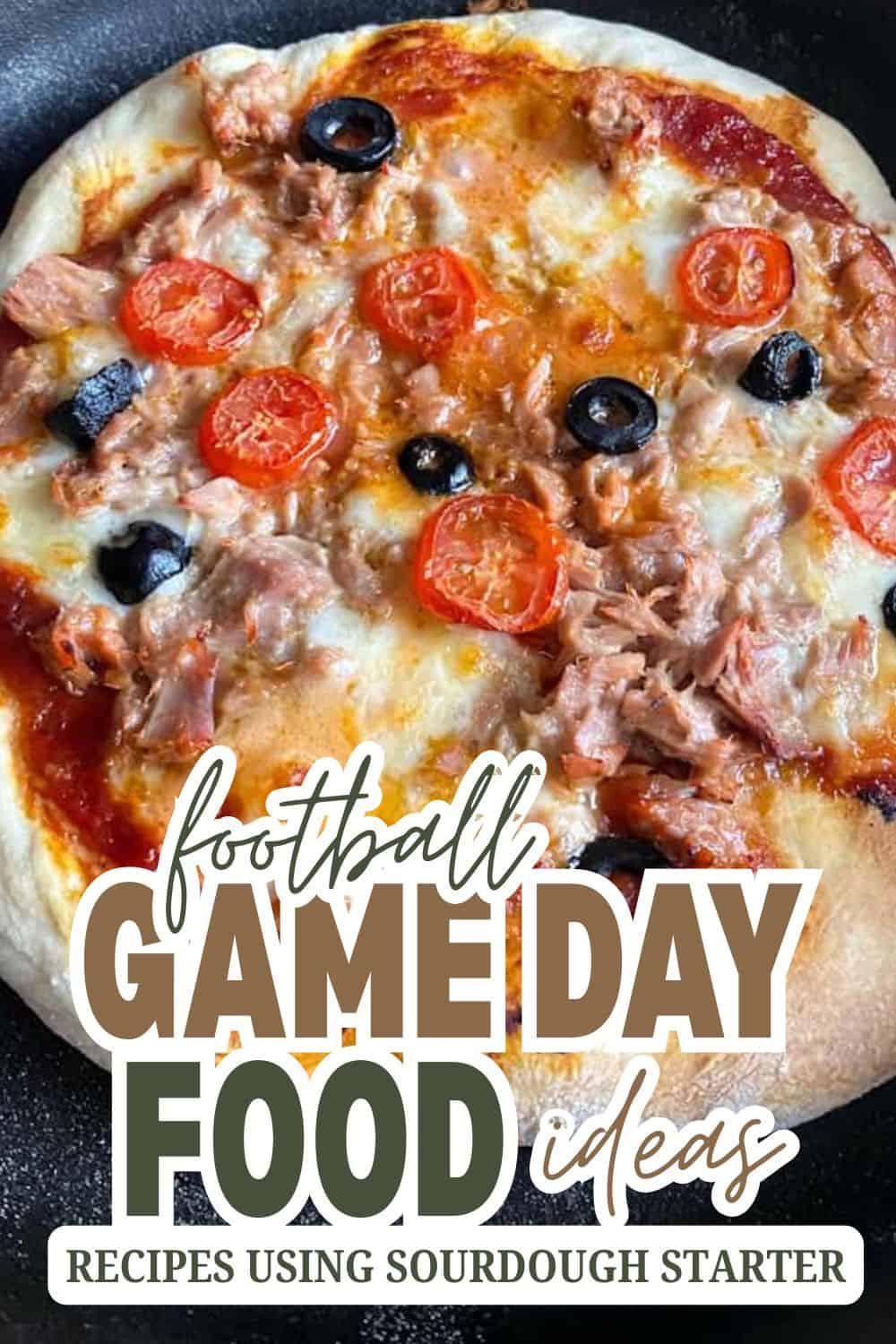 Delicious homemade pizza with cherry tomatoes, black olives, and tuna for game day.